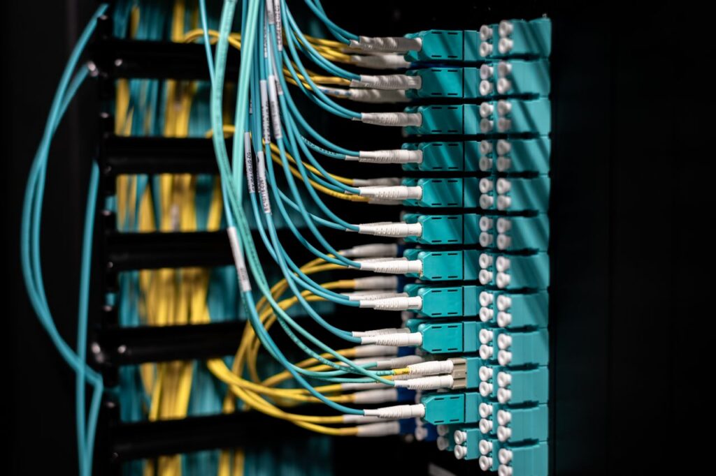 Mastering the First Impression: Your intriguing post title goes here Closeup of switch in server with connectors and adapters connected to plastic device in dark room on blurred background inside