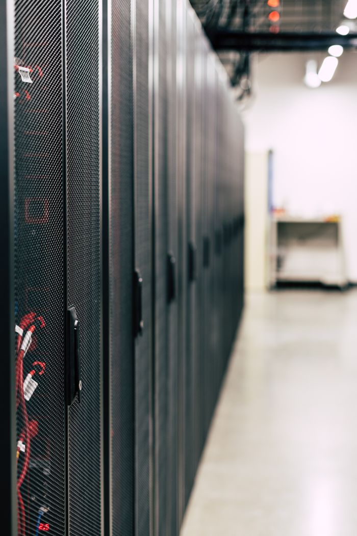 The Art of Drawing Readers In: Your attractive post title goes here Metal black cabinets with servers inside with red wires connected standing in row in lighted room